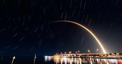 SpaceX's latest Starlink launch streaks to orbit, visible over Titusville's Max Brewer Bridge.  Photo credit: Michael Seeley / We Report Space.