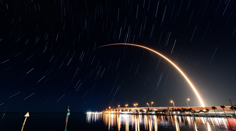 SpaceX's latest Starlink launch streaks to orbit, visible over Titusville's Max Brewer Bridge.  Photo credit: Michael Seeley / We Report Space.