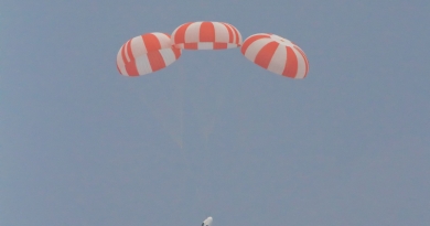 SpaceX's Crew Dragon Pad Abort Test (2015) shows the Dragon spacecraft gently floating back to Earth with parachutes deployed.  Photo credit: Michael Seeley / We Report Space
