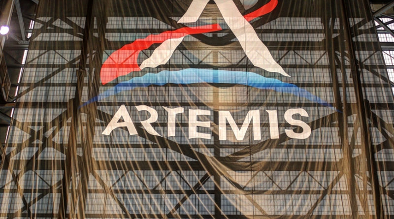 A large Artemis mission flag hangs inside NASA's Vehicle Assembly Building.  Photo credit: Michael Howard / We Report Space