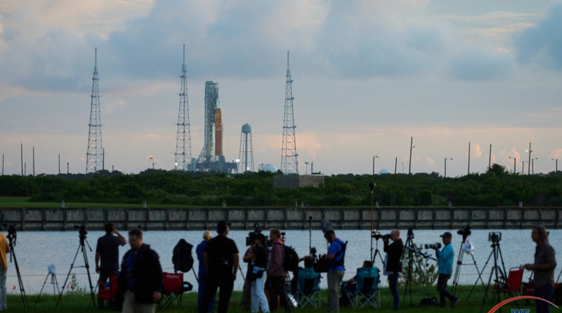 Photojournalists line the banks of the turning basin at Launch Complex 39's Press Site.  Photo credit: Jared Haworth / We Report Space.